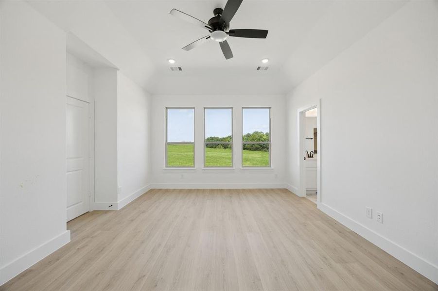 Empty room with light wood finished floors, a ceiling fan, and recessed lighting Empty room with light wood finished floors, a ceiling fan, and recessed lighting