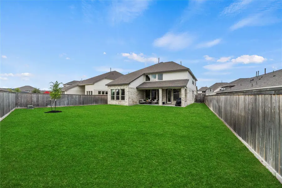 This pool-worthy fenced yard offers endless possibilities for fun and relaxation, with plenty of space for entertaining, play, or creating your dream outdoor retreat, all kept lush and vibrant year-round by the full sprinkler system.