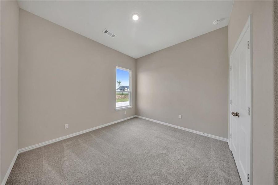 Unfurnished room with carpet floors and a smoke detector Unfurnished room with carpet floors and a smoke detector