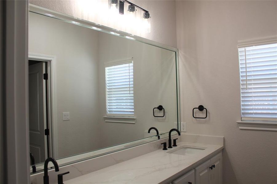 Bathroom featuring vanity and healthy amount of natural light Bathroom featuring vanity and healthy amount of natural light