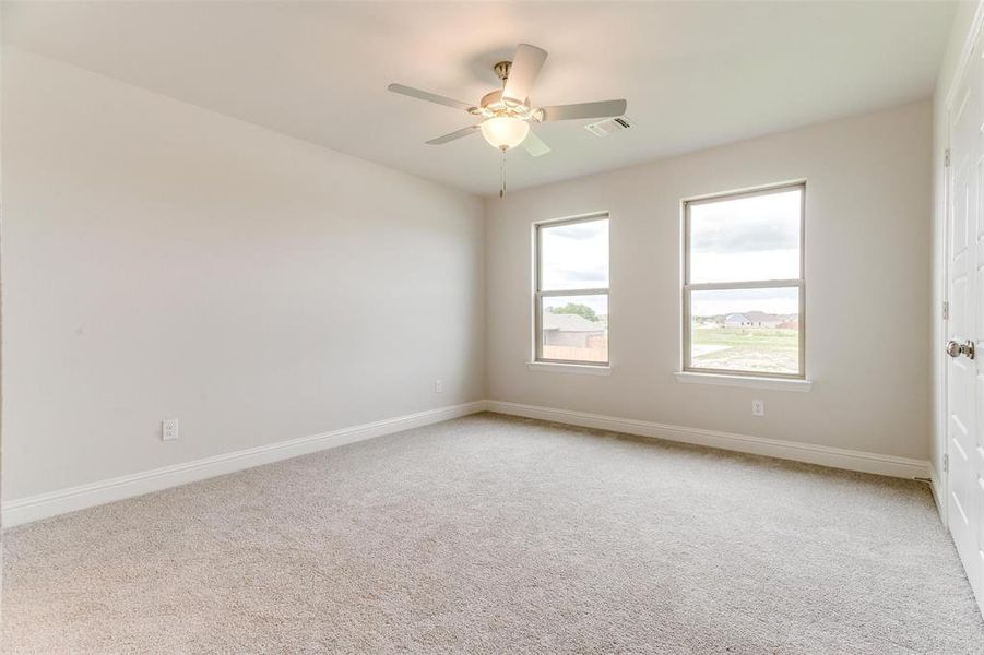 Spare room with light carpet and ceiling fan