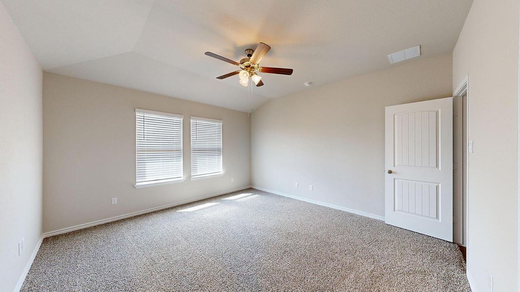 Empty room with light colored carpet, ceiling fan, and lofted ceiling