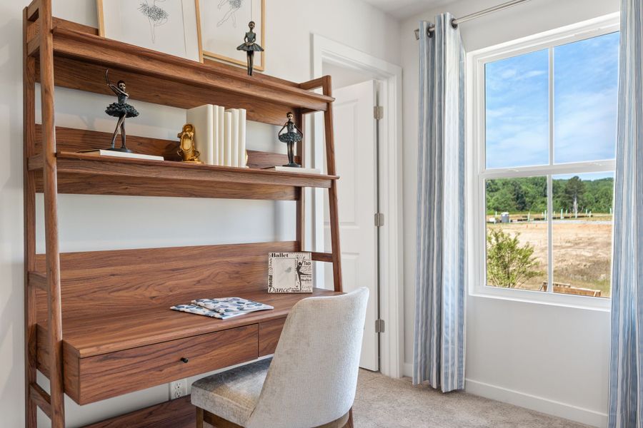A chair and a desk in a room with windows. A chair and a desk in a room with windows.