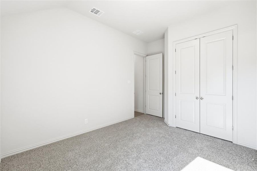 Unfurnished bedroom featuring carpet flooring and a closet