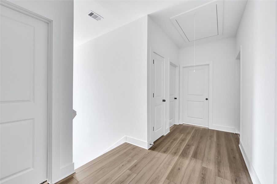 Bright hallway connecting the living space to upstairs bedrooms. Bright hallway connecting the living space to upstairs bedrooms.