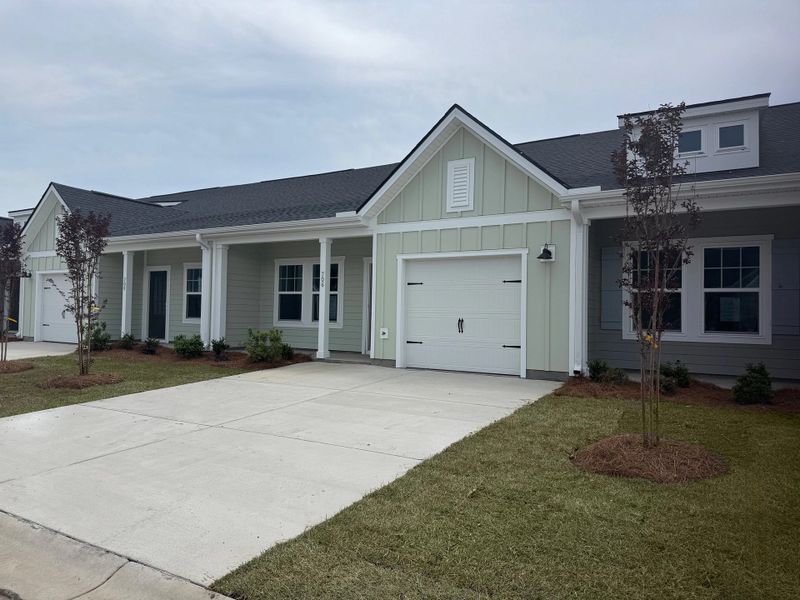 Front exterior of a new home in Blue Heron Retreat, Little River, SC, highlighting curb appeal (Image 13). Front exterior of a new home in Blue Heron Retreat, Little River, SC, highlighting curb appeal (Image 13).