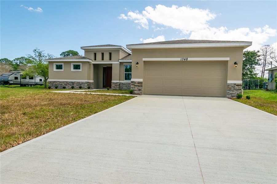 Front exterior of a new home in , Palm Bay, FL, highlighting curb appeal (Image 2). Front exterior of a new home in , Palm Bay, FL, highlighting curb appeal (Image 2).