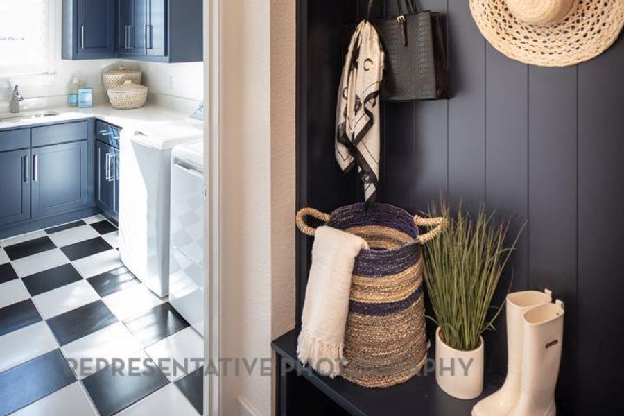 Laundry room featuring cabinet space, washing machine and clothes dryer, and light flooring Laundry room featuring cabinet space, washing machine and clothes dryer, and light flooring