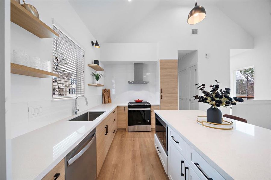 Side view of kitchen features two toned cabinetry and clean lines.