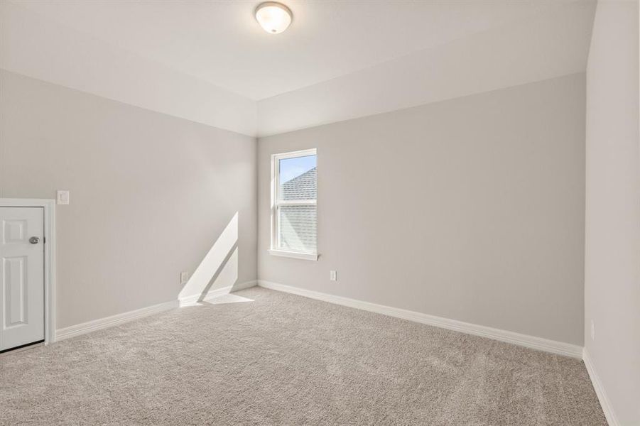 Your secondary bedroom features plush carpet, fresh paint, closet, and a large window that lets in plenty of natural lighting.