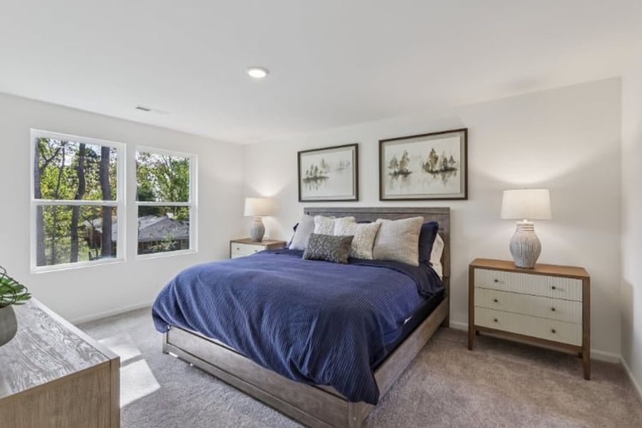 A bedroom with a bed and lamps.