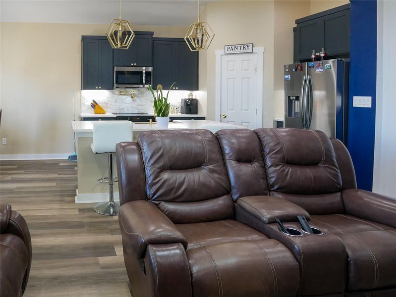 Living area with dark wood-style flooring and baseboards