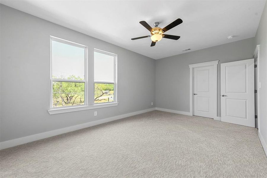 Unfurnished bedroom with carpet floors and ceiling fan