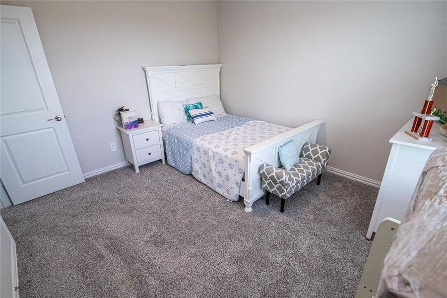 Carpeted bedroom featuring baseboards Carpeted bedroom featuring baseboards