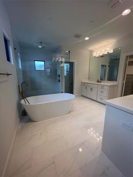 Bathroom featuring plus walk in shower, vanity, and tile floors