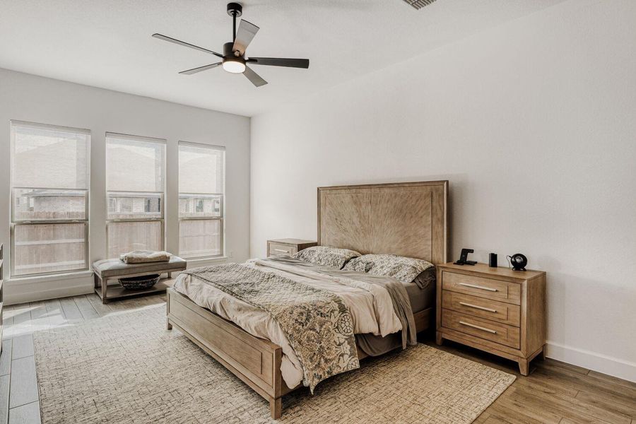 Bedroom featuring ceiling fan and light wood-type flooring