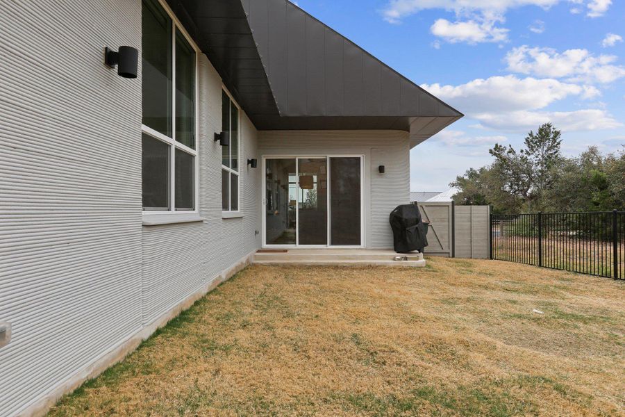 Back of property featuring a patio and a fenced backyard