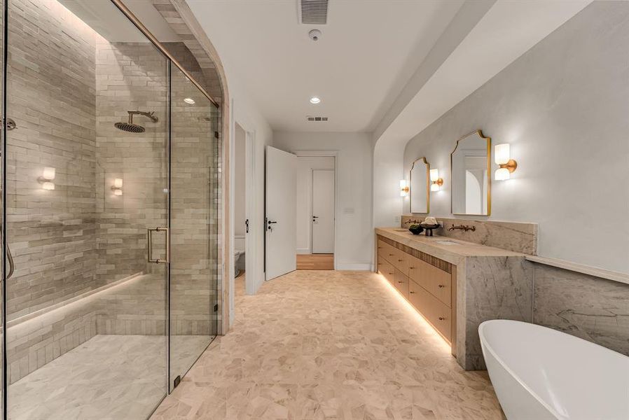 Bathroom featuring double vanity, a freestanding tub, a shower stall, and recessed lighting Bathroom featuring double vanity, a freestanding tub, a shower stall, and recessed lighting