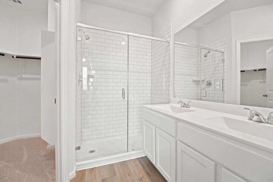Clean lines and white subway tile define this modern bathroom with a double vanity.