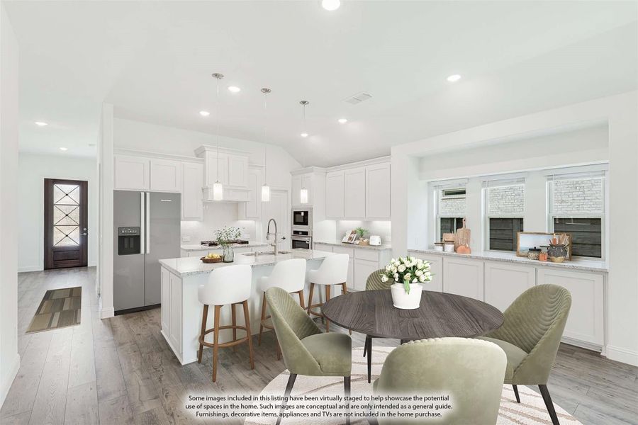 Open-concept kitchen and dining area with white cabinets, large island, stainless appliances, and hardwood floors Open-concept kitchen and dining area with white cabinets, large island, stainless appliances, and hardwood floors