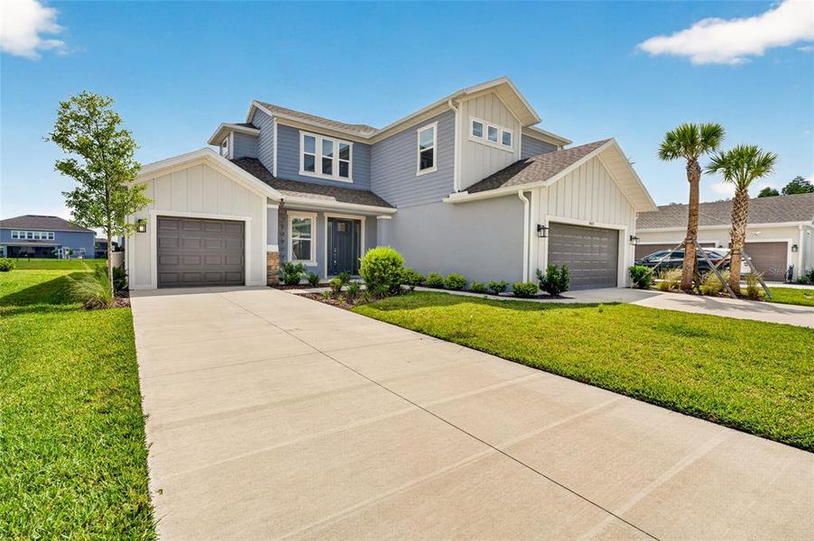 Front exterior of a new home in River Landing, Wesley Chapel, FL, highlighting curb appeal (Image 26). Front exterior of a new home in River Landing, Wesley Chapel, FL, highlighting curb appeal (Image 26).