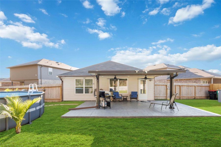 Backyard & Covered Patio ViewExpansive backyard designed for endless entertaining and relaxation, featuring an extended covered patio with ceiling fans, space for outdoor dining and lounging, and seamless indoor-outdoor flow. The above-ground pool adds summer fun, while the fully fenced yard provides privacy and room for gatherings, play, or pets. A perfect setup for hosting, weekend barbecues, or unwinding in your own private outdoor retreat. Backyard & Covered Patio ViewExpansive backyard designed for endless entertaining and relaxation, featuring an extended covered patio with ceiling fans, space for outdoor dining and lounging, and seamless indoor-outdoor flow. The above-ground pool adds summer fun, while the fully fenced yard provides privacy and room for gatherings, play, or pets. A perfect setup for hosting, weekend barbecues, or unwinding in your own private outdoor retreat.
