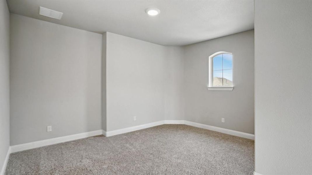 Carpeted spare room with baseboards Carpeted spare room with baseboards