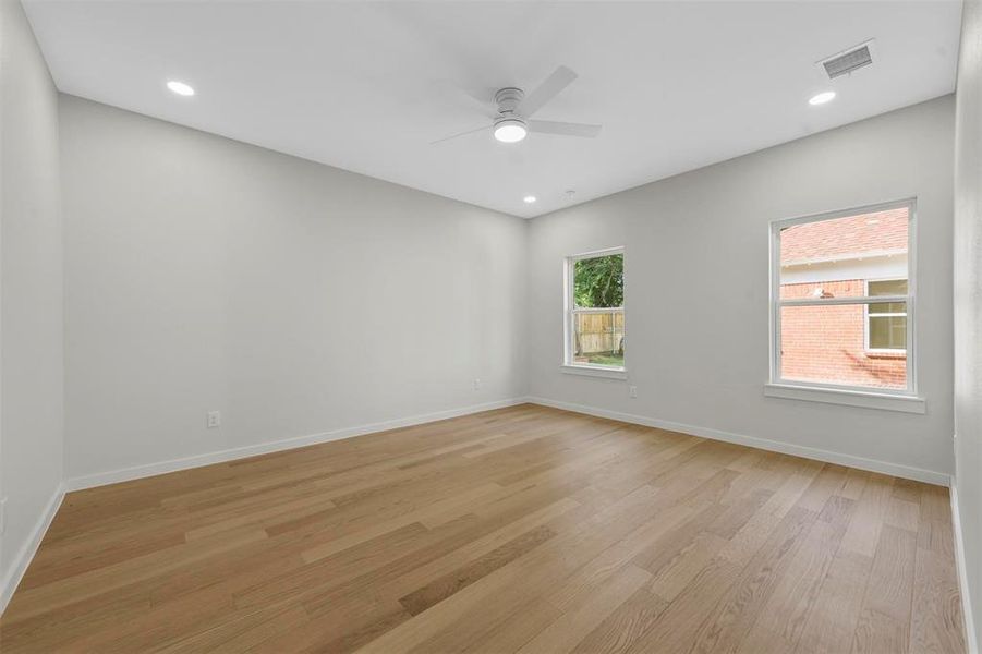 Empty room featuring light hardwood / wood-style floors and ceiling fan