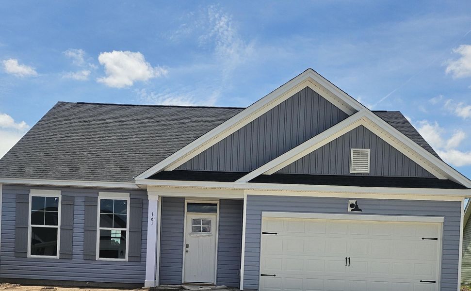 Front exterior of a new home in Edgefield, Loris, SC, highlighting curb appeal (Image 11). Front exterior of a new home in Edgefield, Loris, SC, highlighting curb appeal (Image 11).