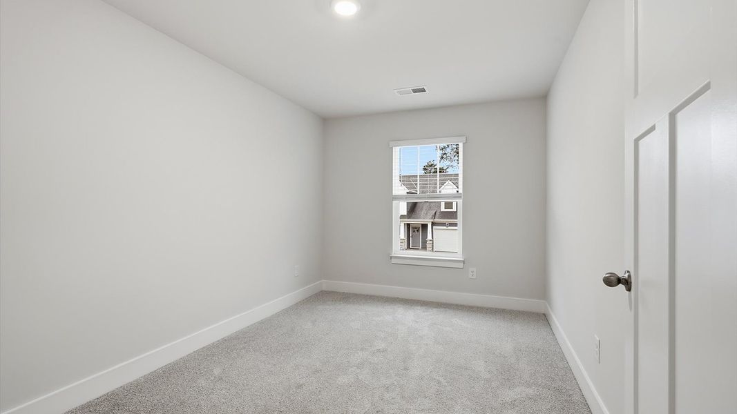 Memorable space with walk-in closet, soft carpeting, and striking natural light from a large window Memorable space with walk-in closet, soft carpeting, and striking natural light from a large window