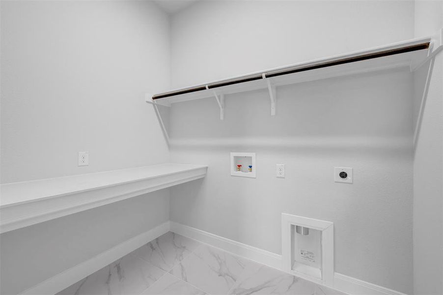 Laundry area with light marble finish flooring, hookup for a washing machine, and hookup for an electric dryer Laundry area with light marble finish flooring, hookup for a washing machine, and hookup for an electric dryer