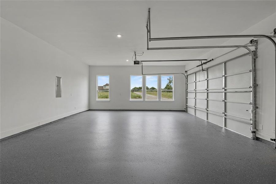 Garage with recessed lighting and a garage door opener