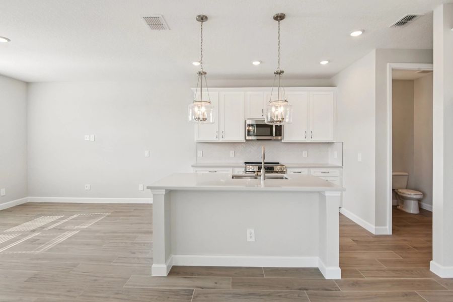 Large island centers the beautiful AW Collection® Timeless kitchen