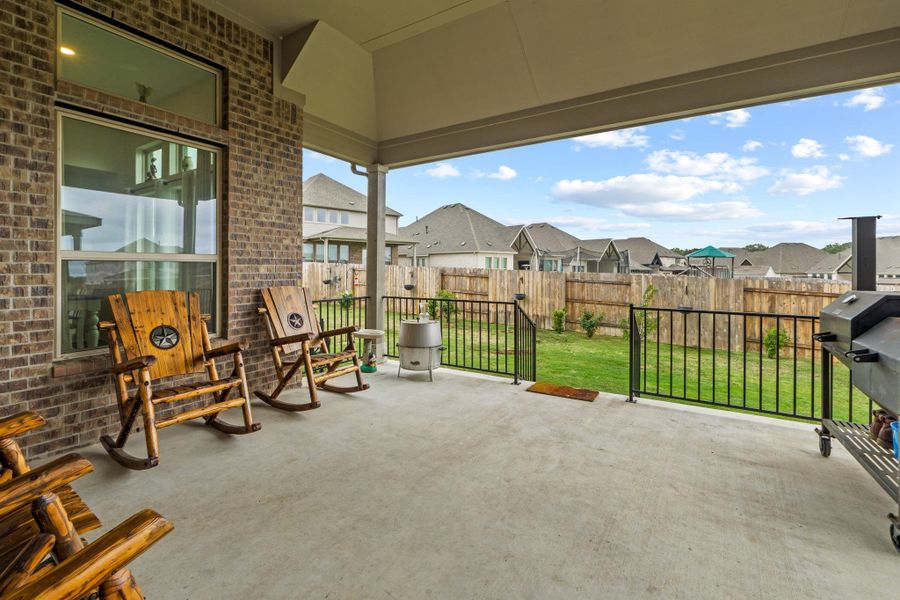 Life in Kyle is meant to be lived outdoors. This oversized covered patio features soaring ceilings and provides a shaded retreat for morning coffee or weekend BBQing.