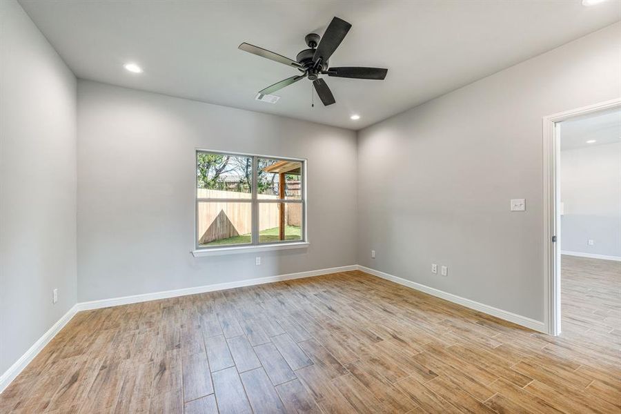 Empty room featuring ceiling fan and light hardwood / wood-style flooring