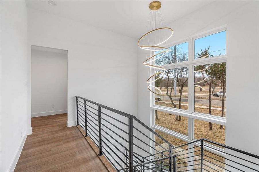 Hall featuring a notable chandelier and hardwood / wood-style floors