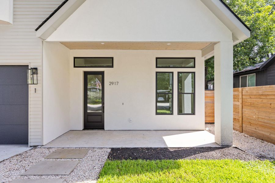Property entrance with a garage and stucco siding Property entrance with a garage and stucco siding