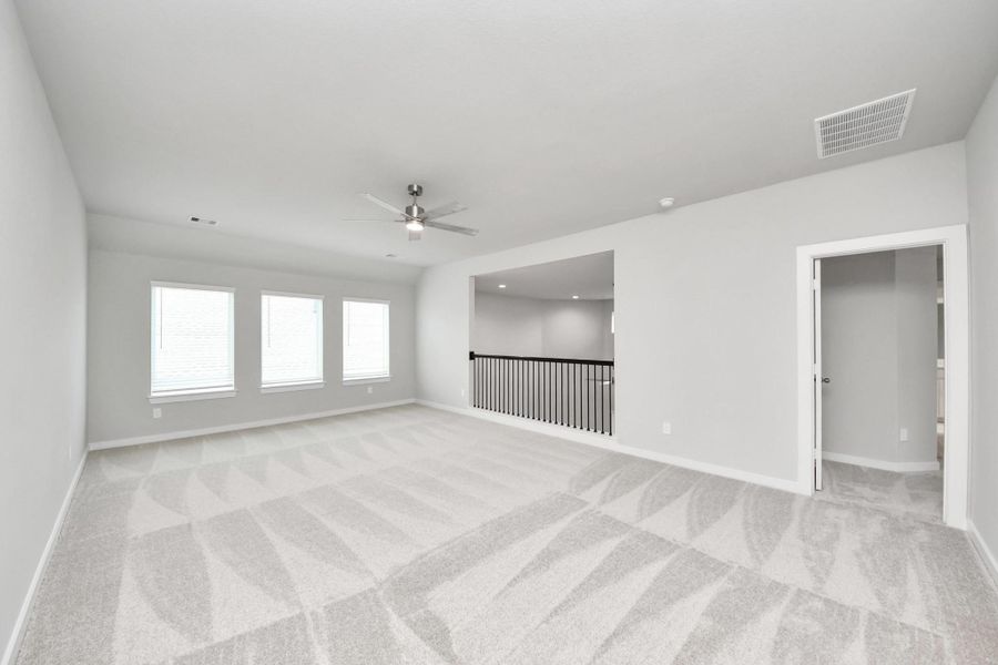 Come upstairs and enjoy a day of leisure in this fabulous game room! This is the perfect hangout spot or adult game room! Features plush carpet, high ceilings, custom paint and windows for plenty of natural light. Sample photo of completed home with similar floor plan. Actual colors and selections may vary. Come upstairs and enjoy a day of leisure in this fabulous game room! This is the perfect hangout spot or adult game room! Features plush carpet, high ceilings, custom paint and windows for plenty of natural light. Sample photo of completed home with similar floor plan. Actual colors and selections may vary.
