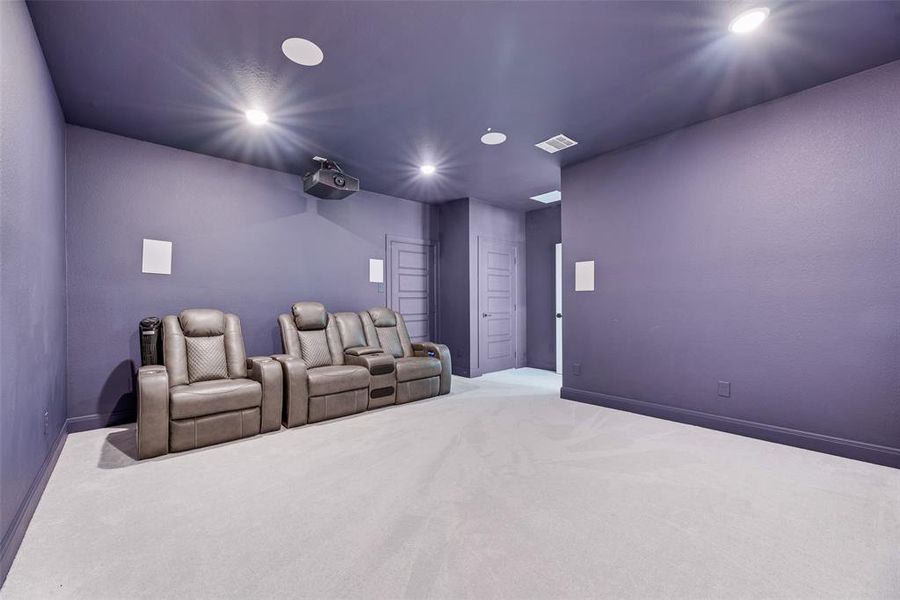 Carpeted home theater featuring baseboards and recessed lighting