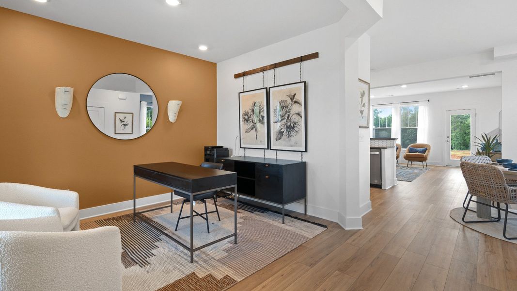 Eye-catching flex room with elegant millwork and seamless access to dining and kitchen at Clarke Townes