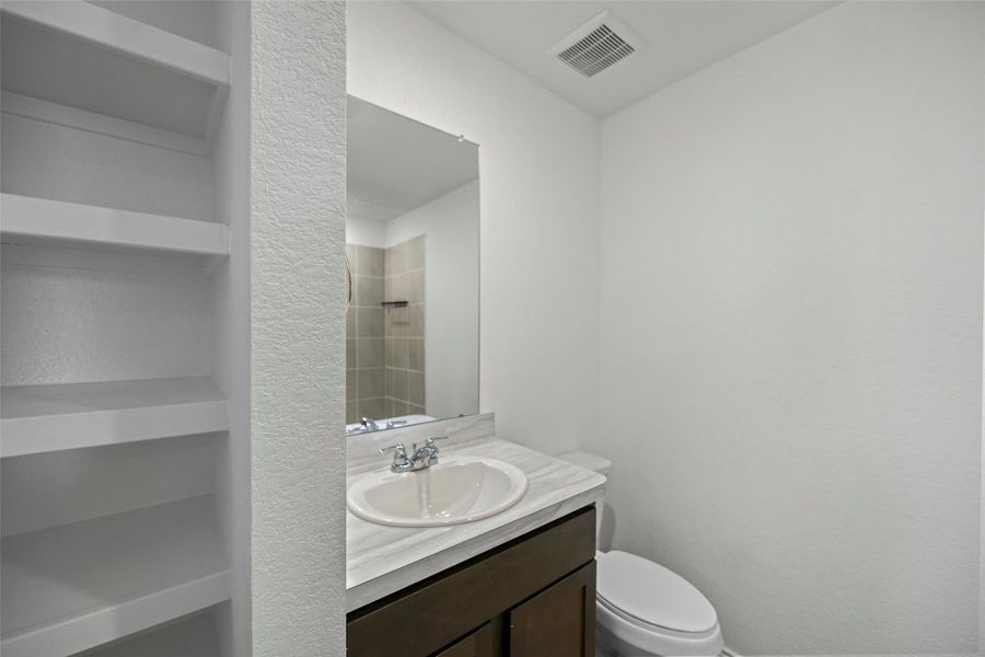 Convenient upstairs bathroom with built-in linen shelving Convenient upstairs bathroom with built-in linen shelving