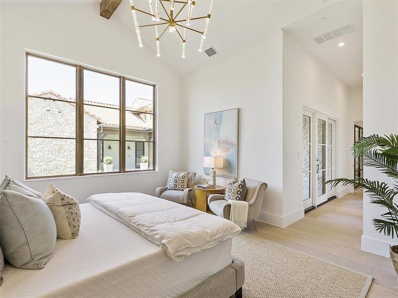 Bedroom with light wood-type flooring, a notable chandelier, beam ceiling, access to outside, and high vaulted ceiling