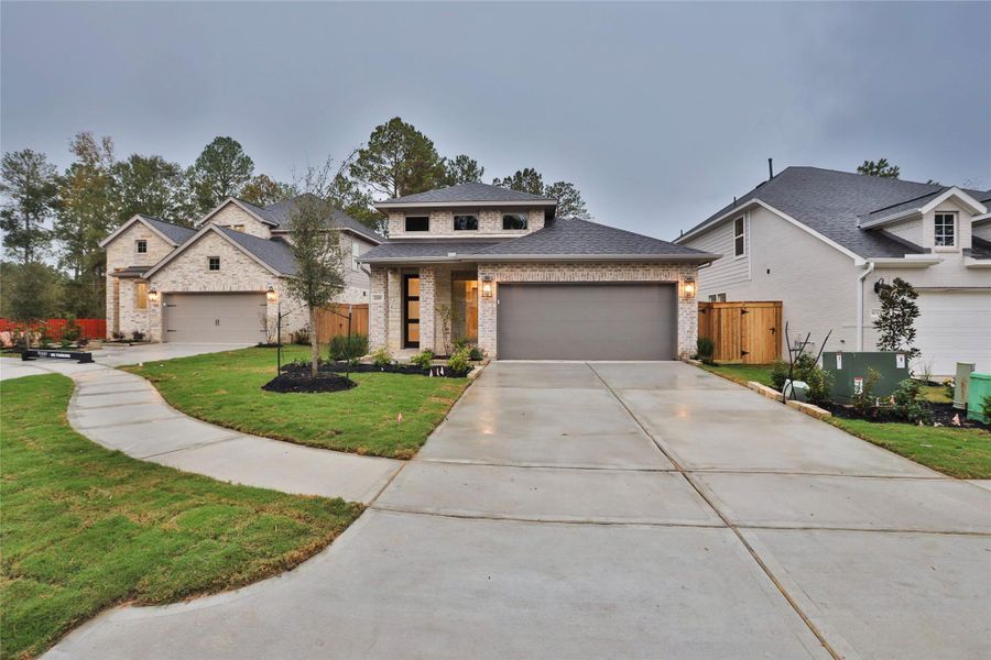 Front exterior of a new home in Woodhavyn 40', Magnolia, TX, highlighting curb appeal (Image 1). Front exterior of a new home in Woodhavyn 40', Magnolia, TX, highlighting curb appeal (Image 1).