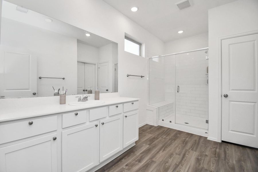 This barely used luxurious bath has dual vanities and elegant finishes — a spa-like experience every day.