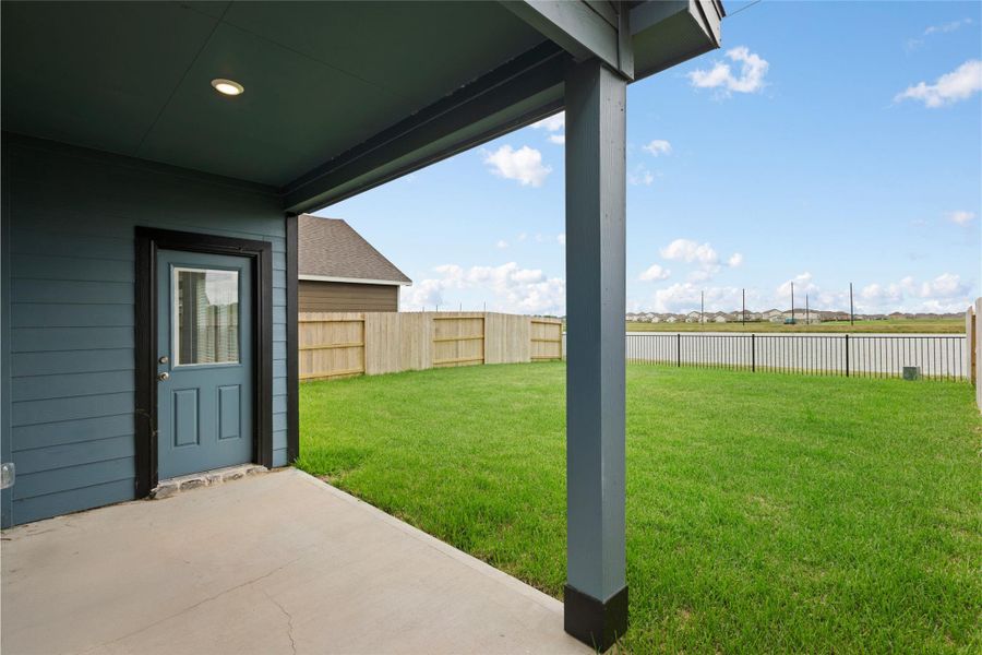 Backyard covered patio with LAKESIDE views.