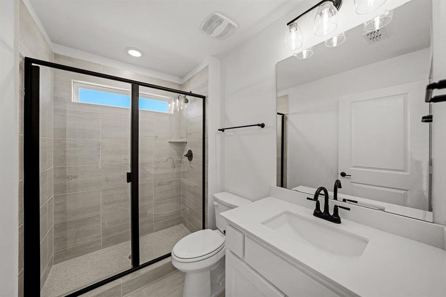 Bathroom with vanity, a shower stall, and recessed lighting