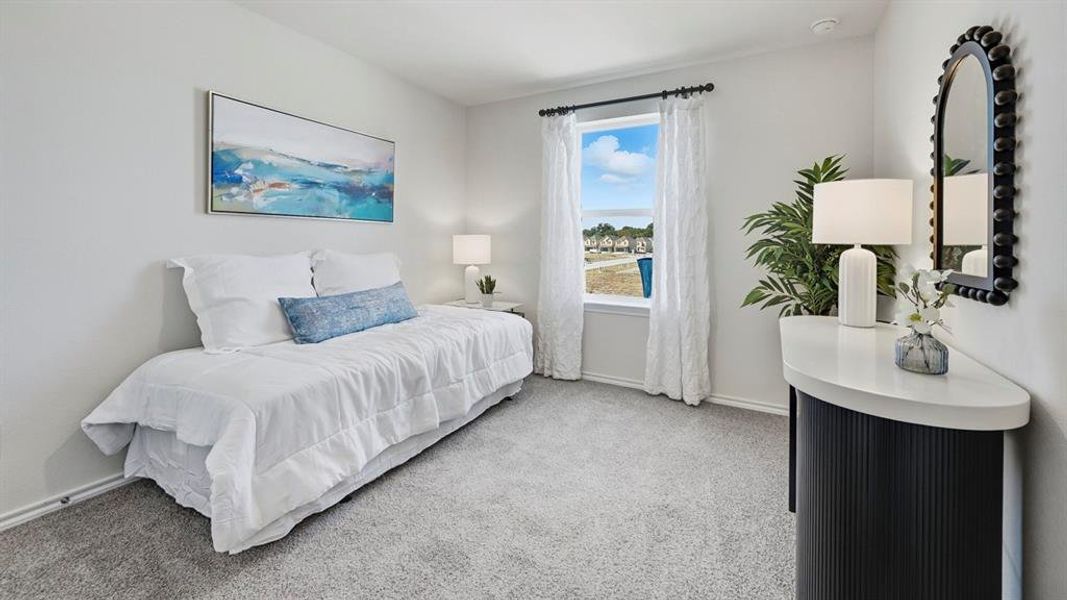 Bedroom featuring light carpet and baseboards Bedroom featuring light carpet and baseboards