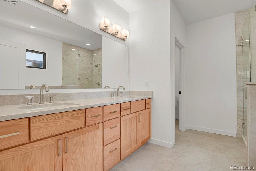 Spa inspired primary bathroom with quartz counter and double vanity Spa inspired primary bathroom with quartz counter and double vanity