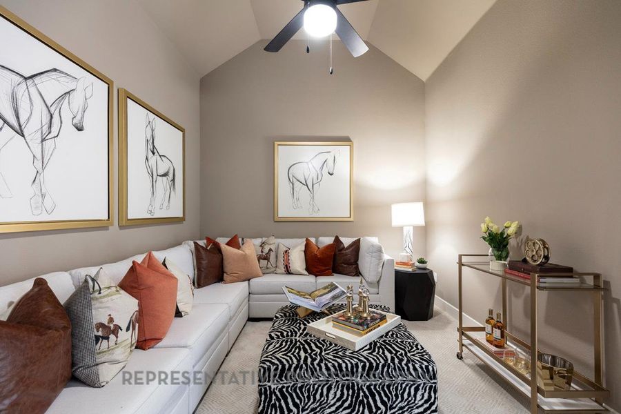 Living room featuring vaulted ceiling, ceiling fan, and light colored carpet Living room featuring vaulted ceiling, ceiling fan, and light colored carpet