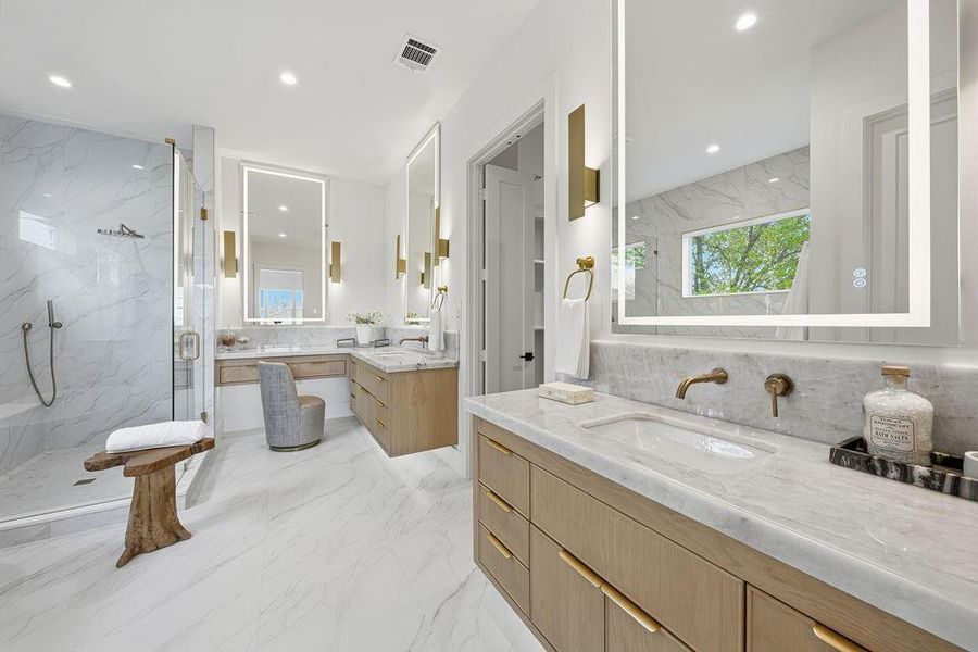Exquisite Craftsmanship Meets Spa-Inspired Utility. The primary bathroom is a masterclass in material selection, blending high-vein Carrara-style marble with the warmth of custom white oak cabinetry. This light-filled space is designed for effortless daily routines and elevated relaxation
